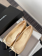 Chanel ladies flats close-up, beige uppers with black toe, lace bow trim
