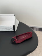 Single Chanel ballet flat in burgundy with black toe cap and pink bow