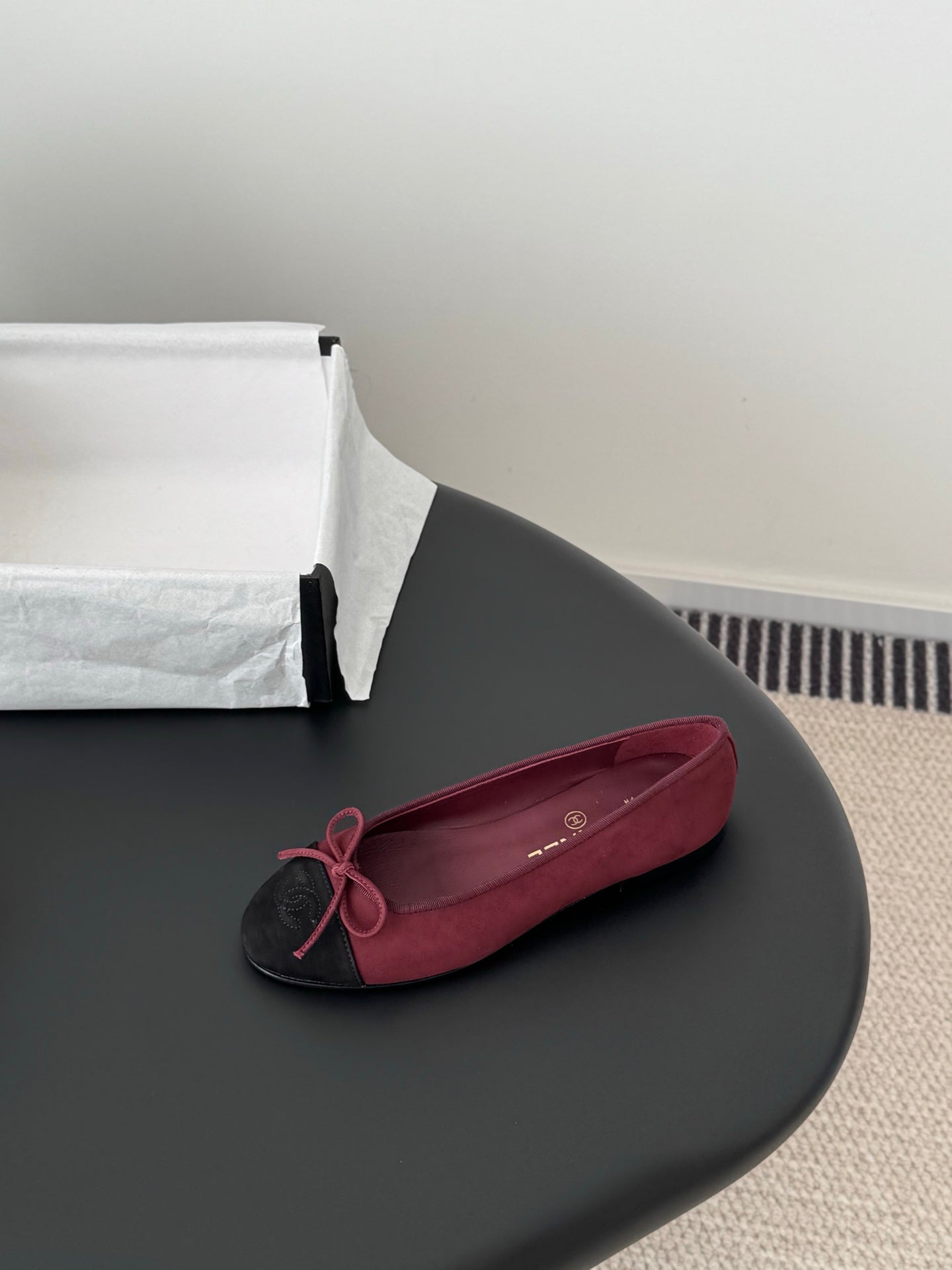 Single Chanel ballet flat in burgundy with black toe cap and pink bow