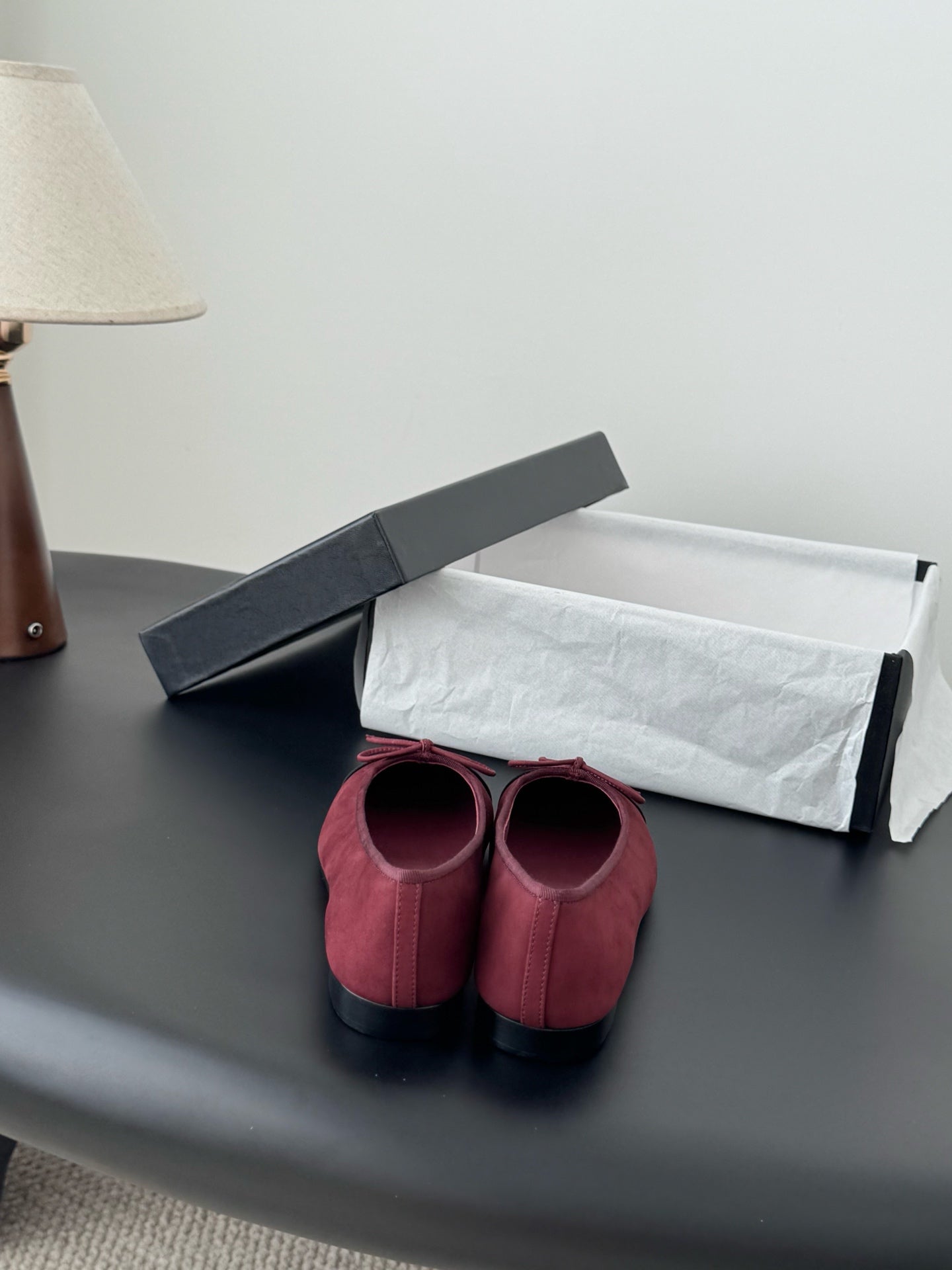 Chanel ballet flats with burgundy fabric and black toe cap, pink bow, viewed from back