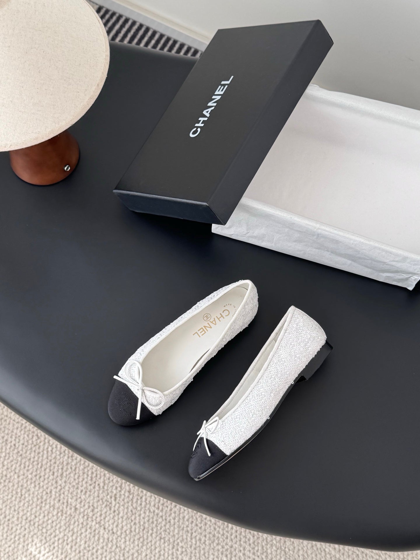Pair of two-tone ballet flats with white textured fabric and bow-tied laces