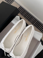 Two-tone ballet flats showing interior and logo on insole, bow-tied lace closure