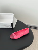 Pink Chanel ballet flat with bow at toe, shown single shoe side view