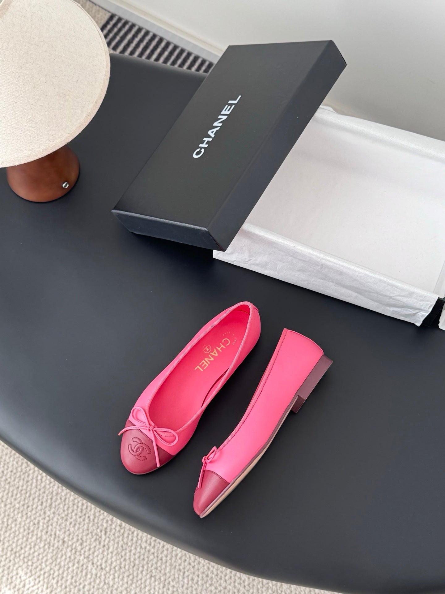 Pair of pink Chanel ballet flats, one shown side view with bow detail