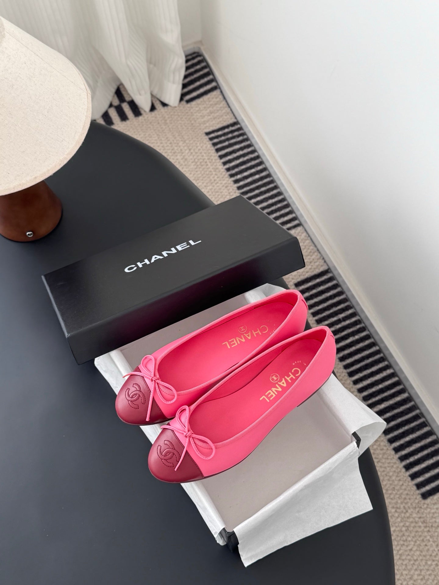 Pink Chanel ballet flats in a pair layout with bow; logo visible