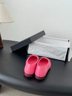 Pink Chanel ballet flats viewed from above; bow ties visible on both shoes
