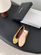 Women's gold ballet flats with ribbon bow, purple logo insole and padded sole