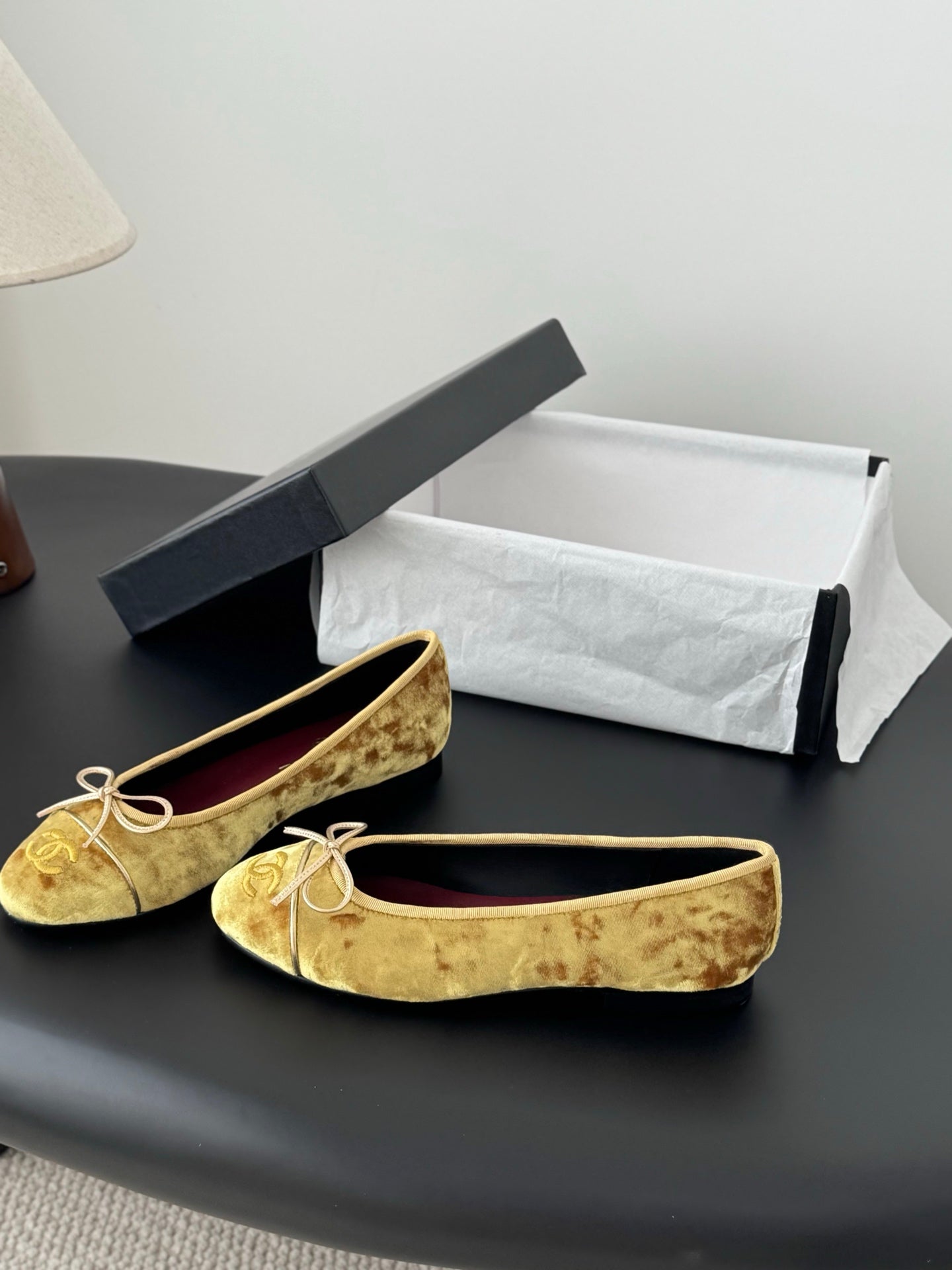 Pair of women's gold ballet flats with ribbon ties and cushioned round toe