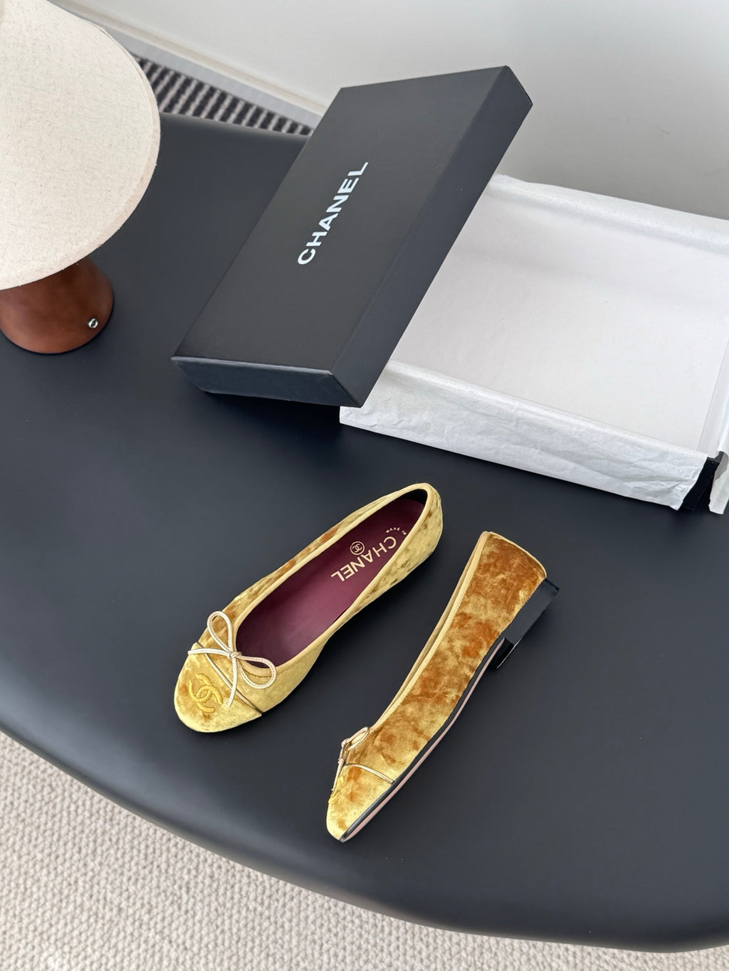 Women's gold velvet ballet flats with ribbon bow and purple logo insole