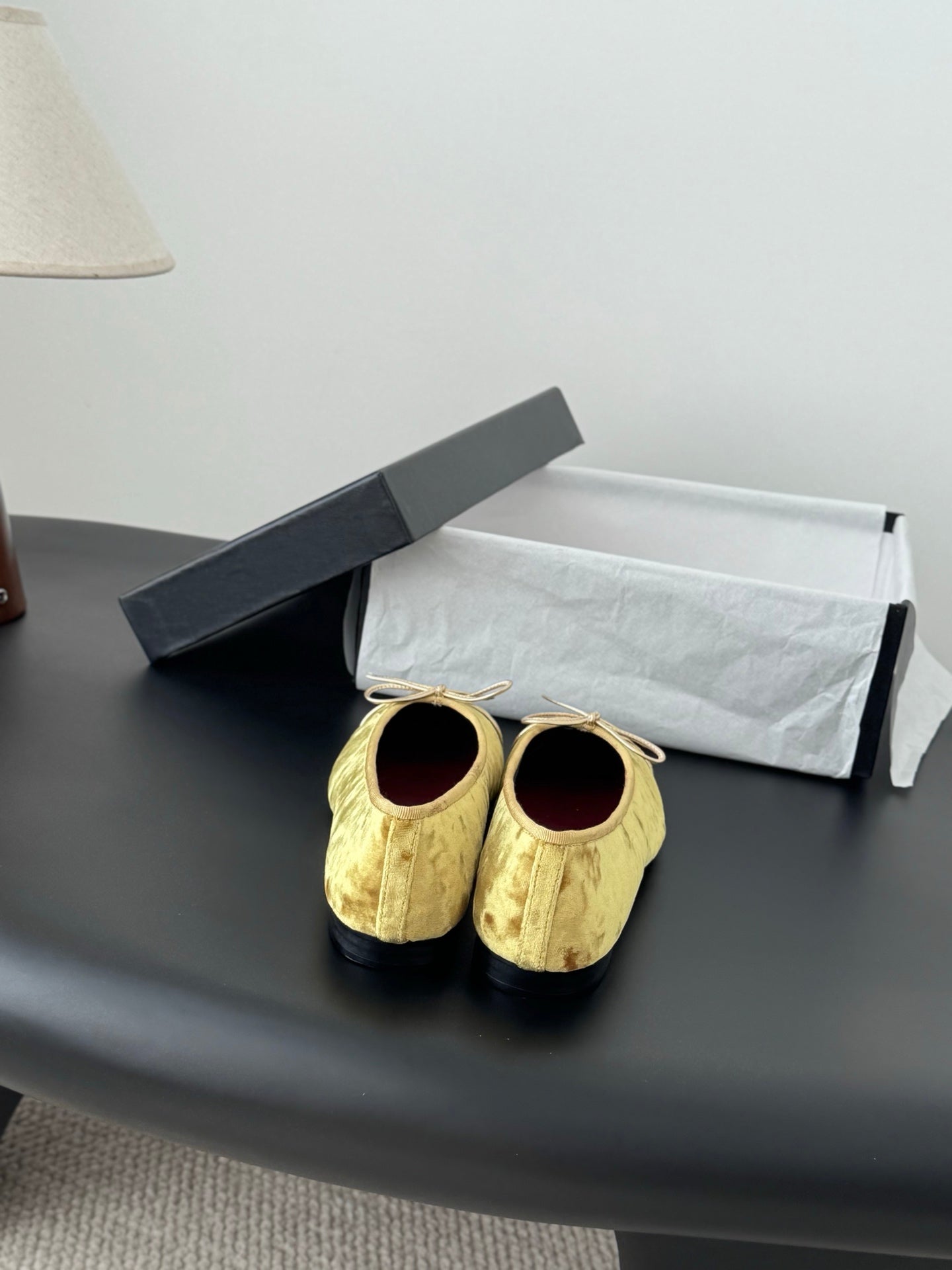 Women's gold ballet flats with ribbon ties, round toe and dark red logo insole