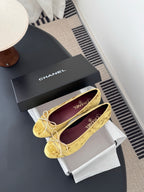 Women's gold ballet flats with ribbon bow and round toe, purple logo insole