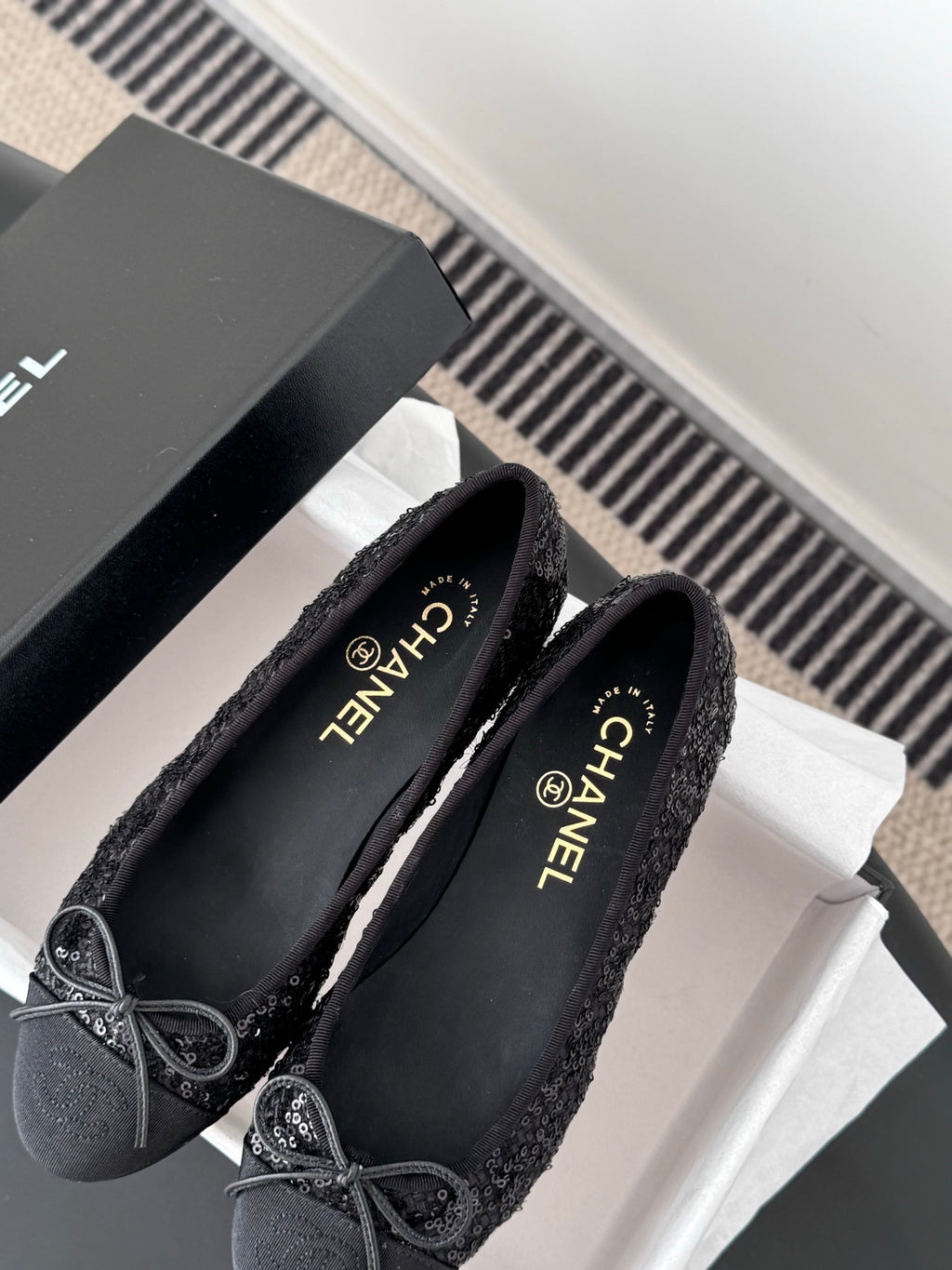 Chanel ladies dark glitter ballet flats with bow ties, shown with CHANEL-branded insole