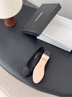 Chanel ladies dark glitter ballet flats with bow ties; light tan outsole detail