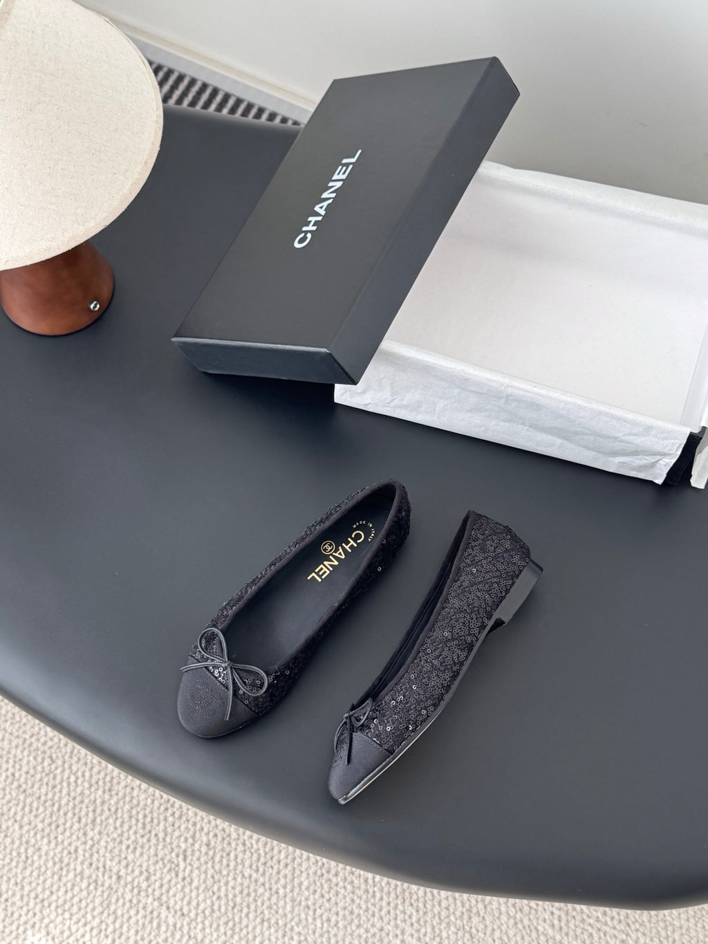 Chanel ladies dark glitter ballet flats, side view with bow ties and round toe