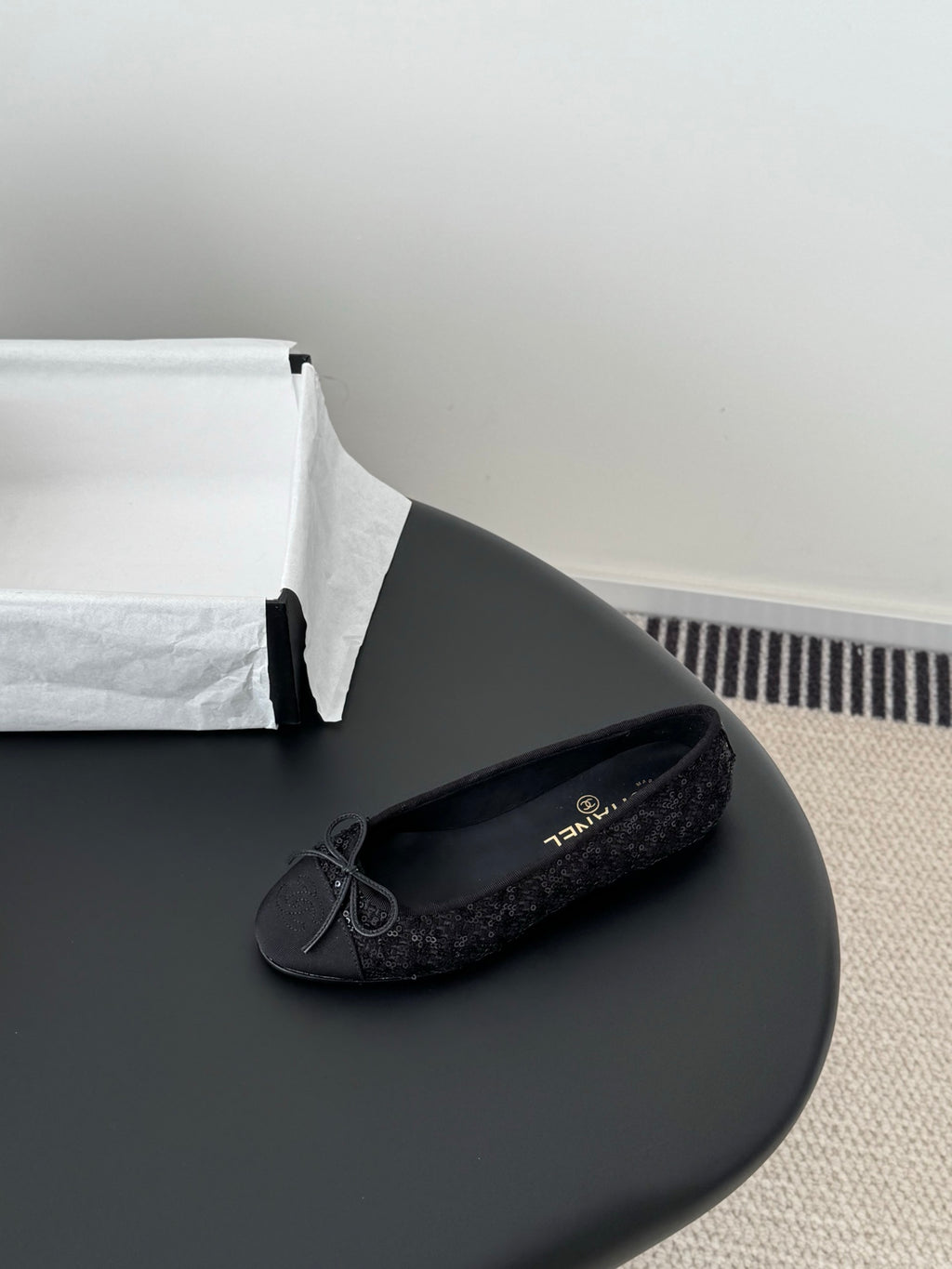 Chanel ladies dark glitter ballet flat with bow tie and round toe, side angle