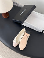 Pale pink and cream ballet flats with lace-up bow and cushioned sole, side view.