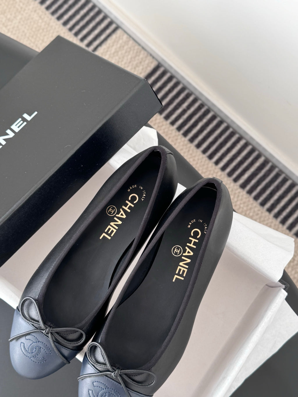 Pair of dark CHANEL ballet flats with ribbon bow and round toe
