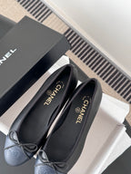 Pair of dark CHANEL ballet flats with ribbon bow and round toe