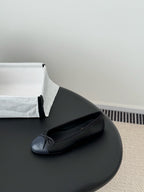Dark ballet flat with ribbon bow and round toe