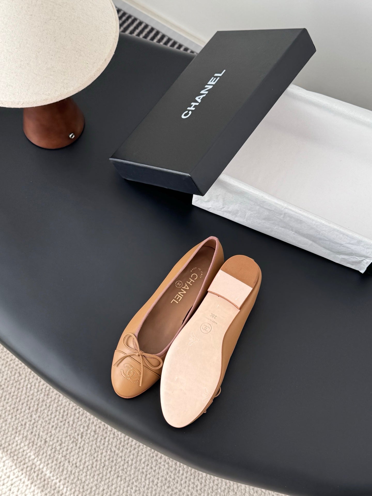 Tan Chanel ballet flats with bow and visible sole underside