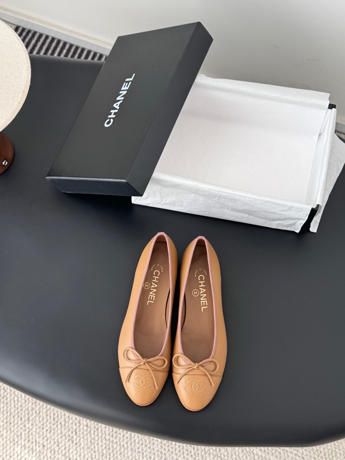 Tan Chanel ballet flats with bow detail and logo embossing
