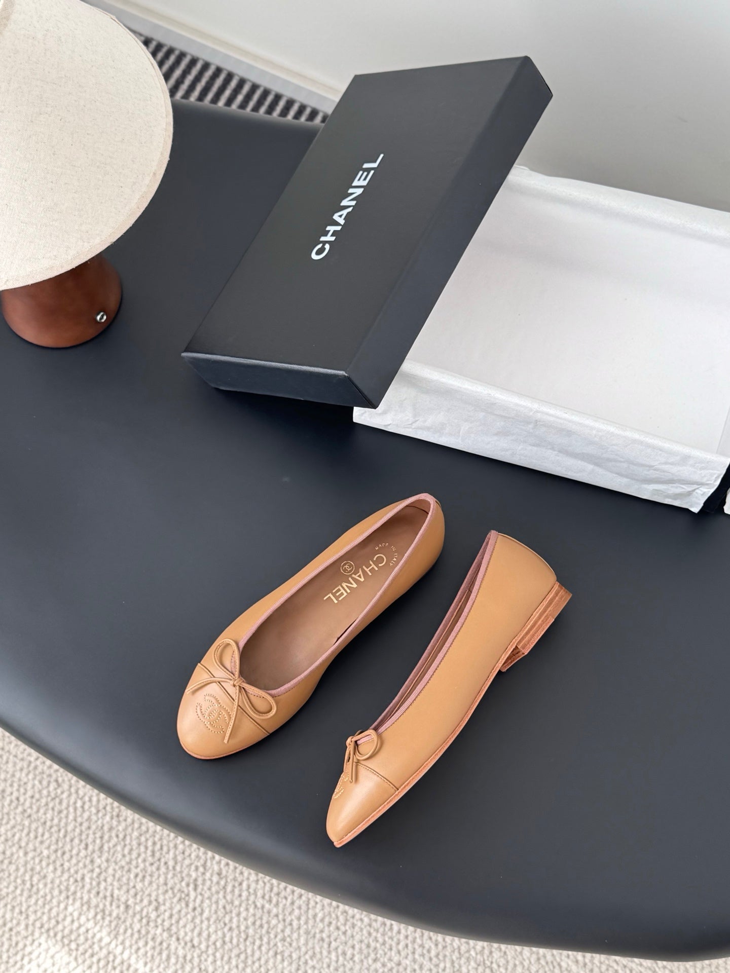 Tan Chanel ballet flats with stitched bow and embossed logo on toe