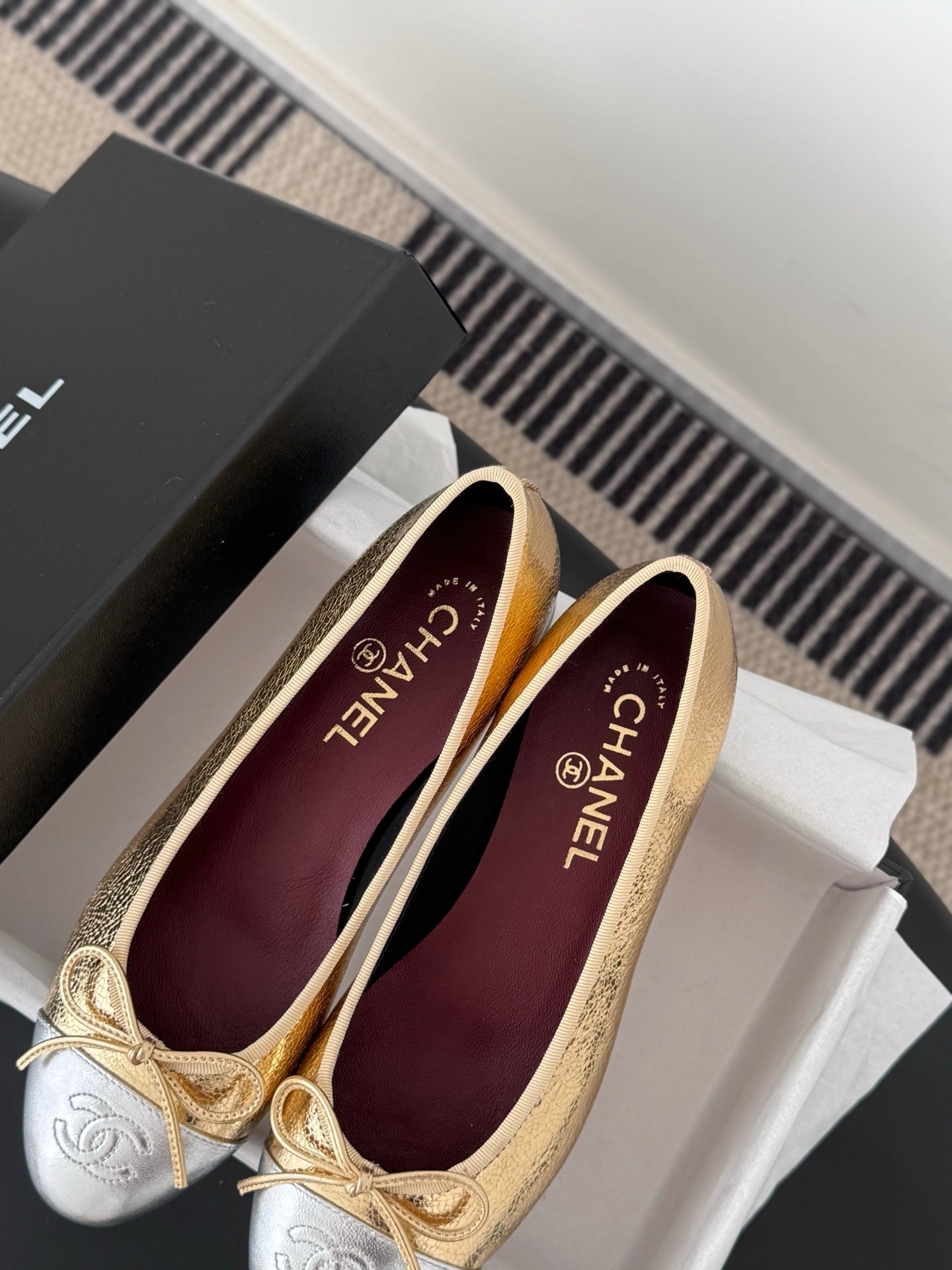 Ballet flats in gold and cream with burgundy lining and bow ties