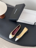 Pair of two-tone ballet flats with round toe, bow ties, and Chanel logos
