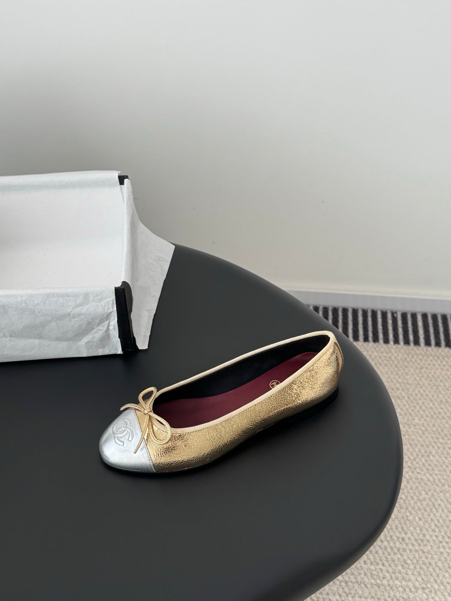 Single gold-and-cream ballet flat with bow laces and round toe