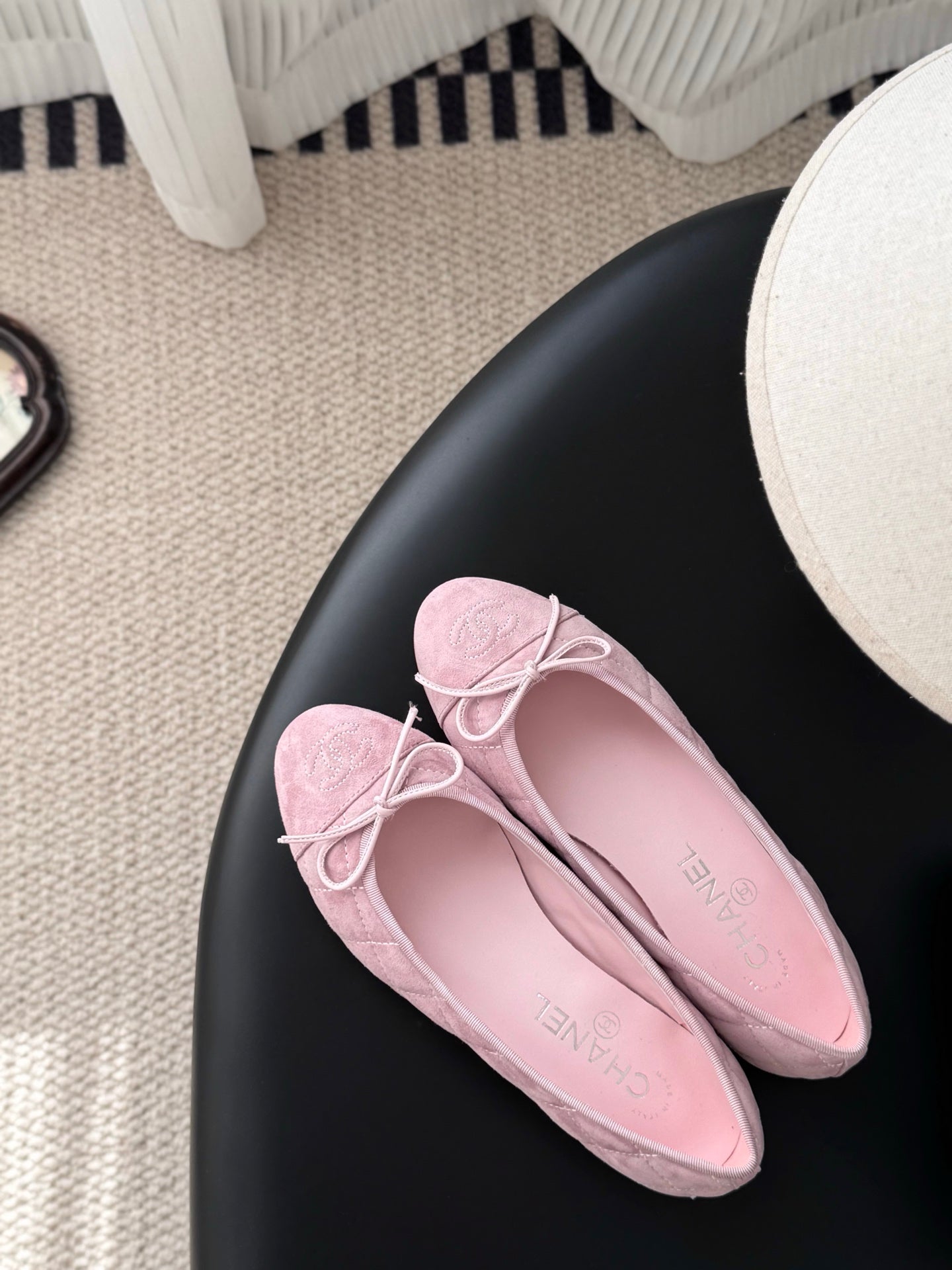 Pink ballet flats with bow laces, rounded toe, suede-like texture