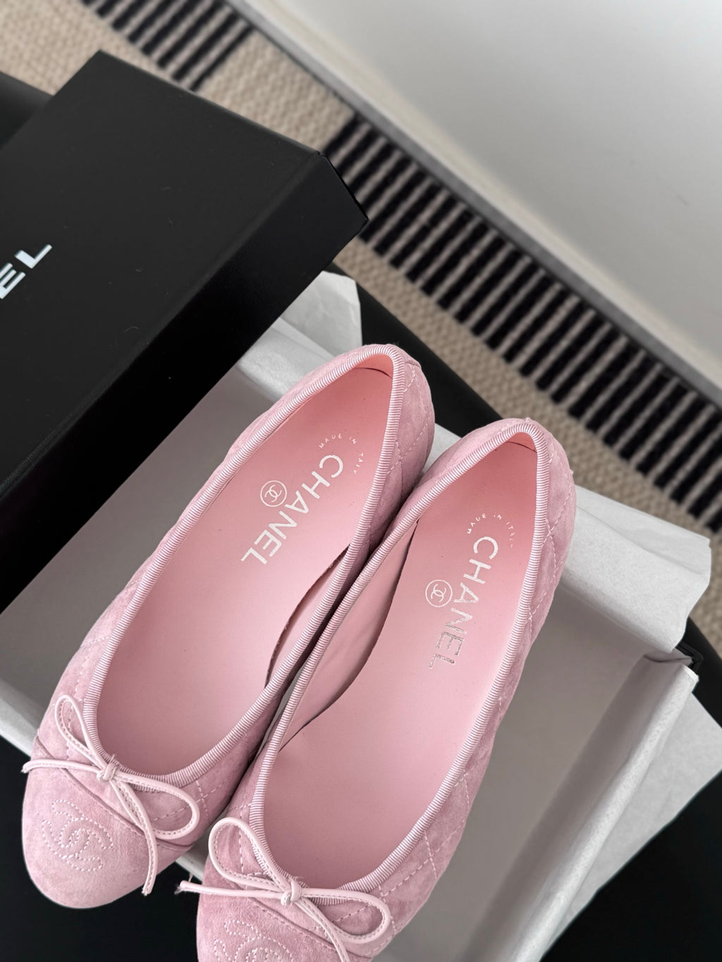 Pink ballet flats with bow laces and Chanel-logo insole