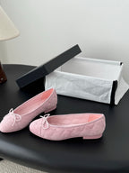 Pink quilted ballet flats with bow laces, rounded toe