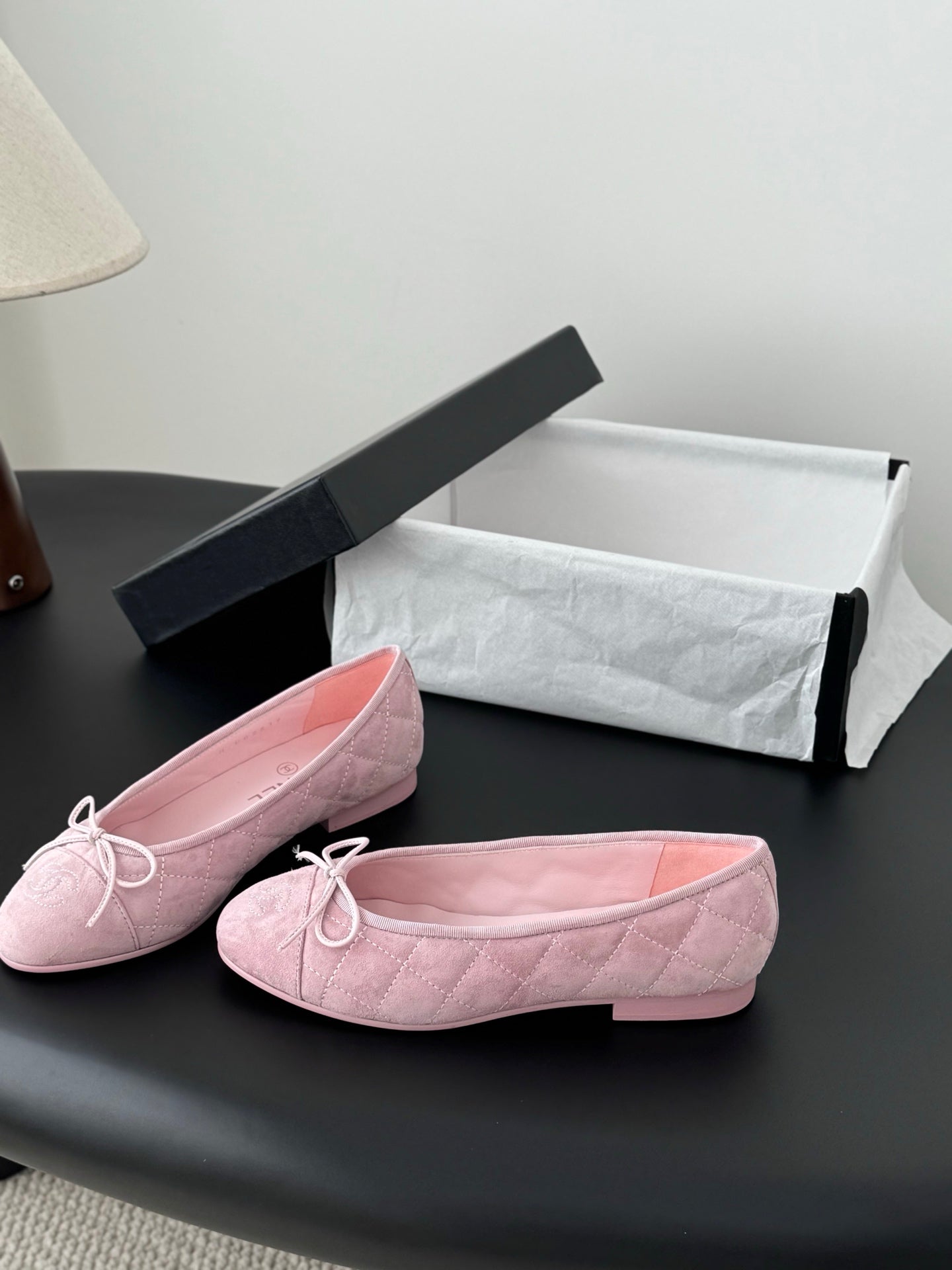 Pink quilted ballet flats with bow laces, rounded toe
