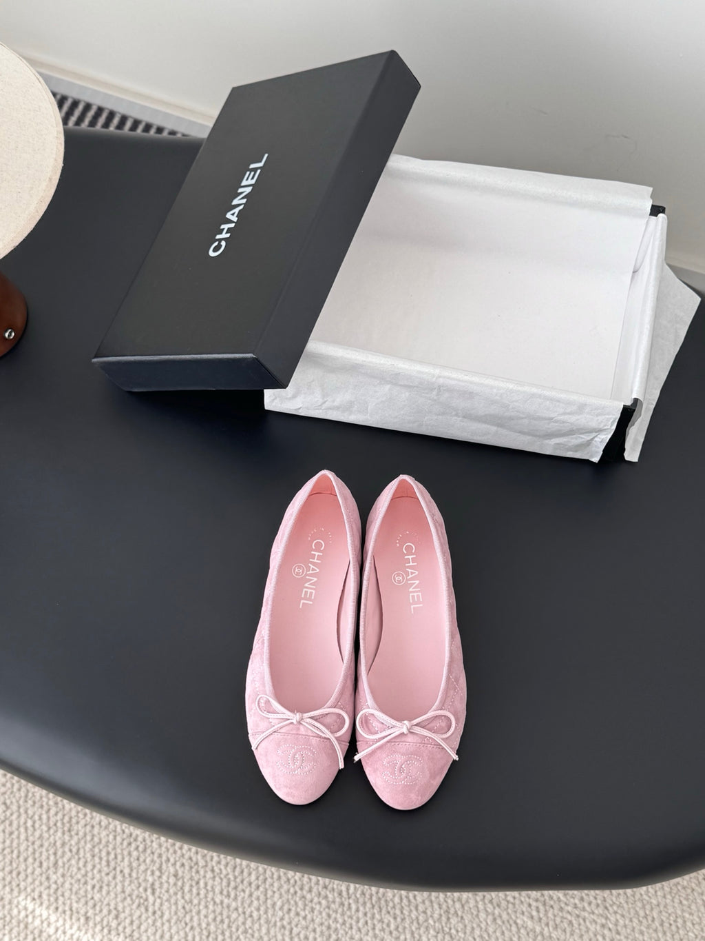 Pink ballet flats with bow ties, textured upper, rounded toe