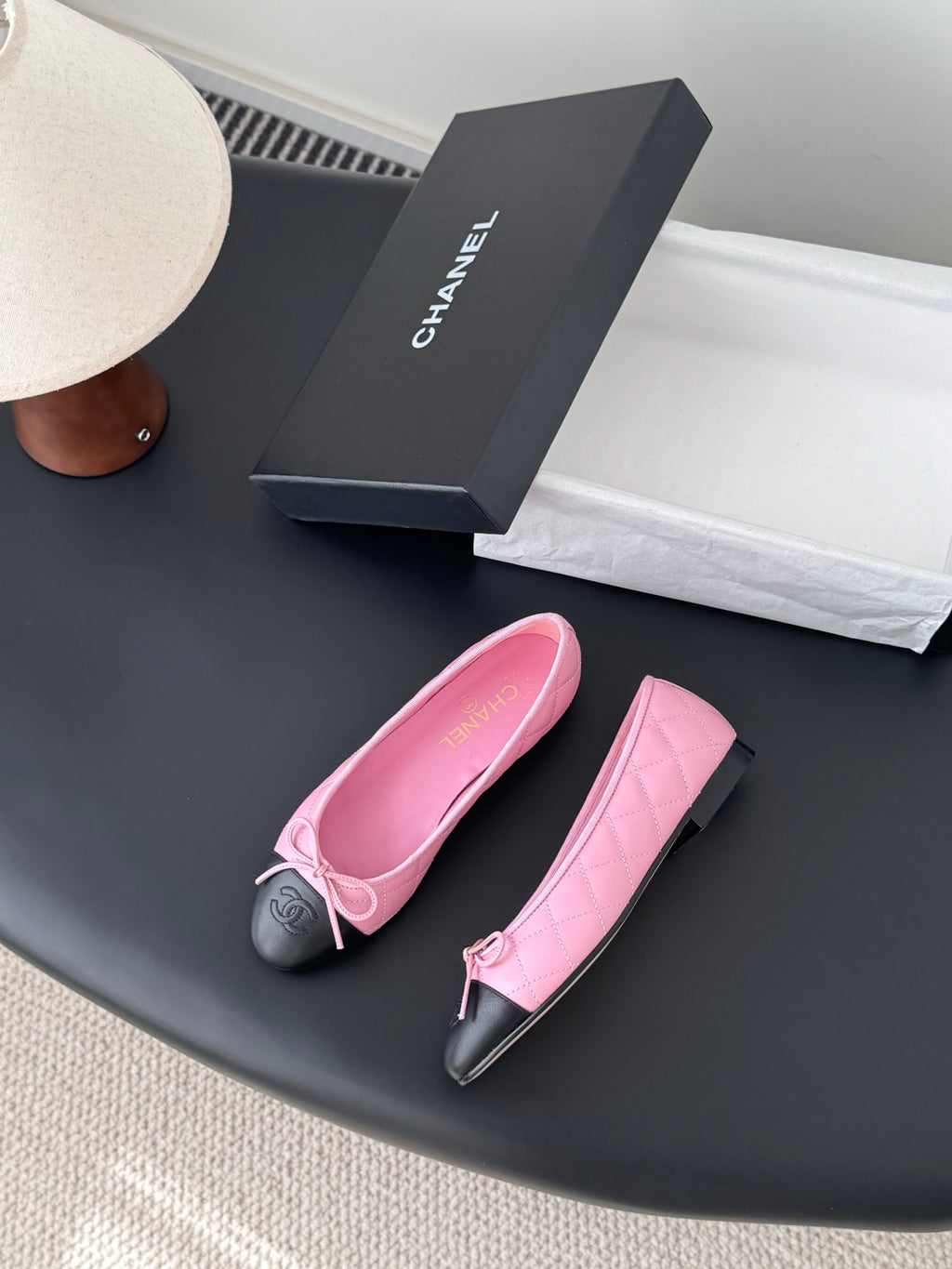 Chanel pink and black ballet flats with bows and glossy black toe detail