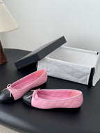 Pair of Chanel pink quilted ballet flats with black toe caps and tied bow