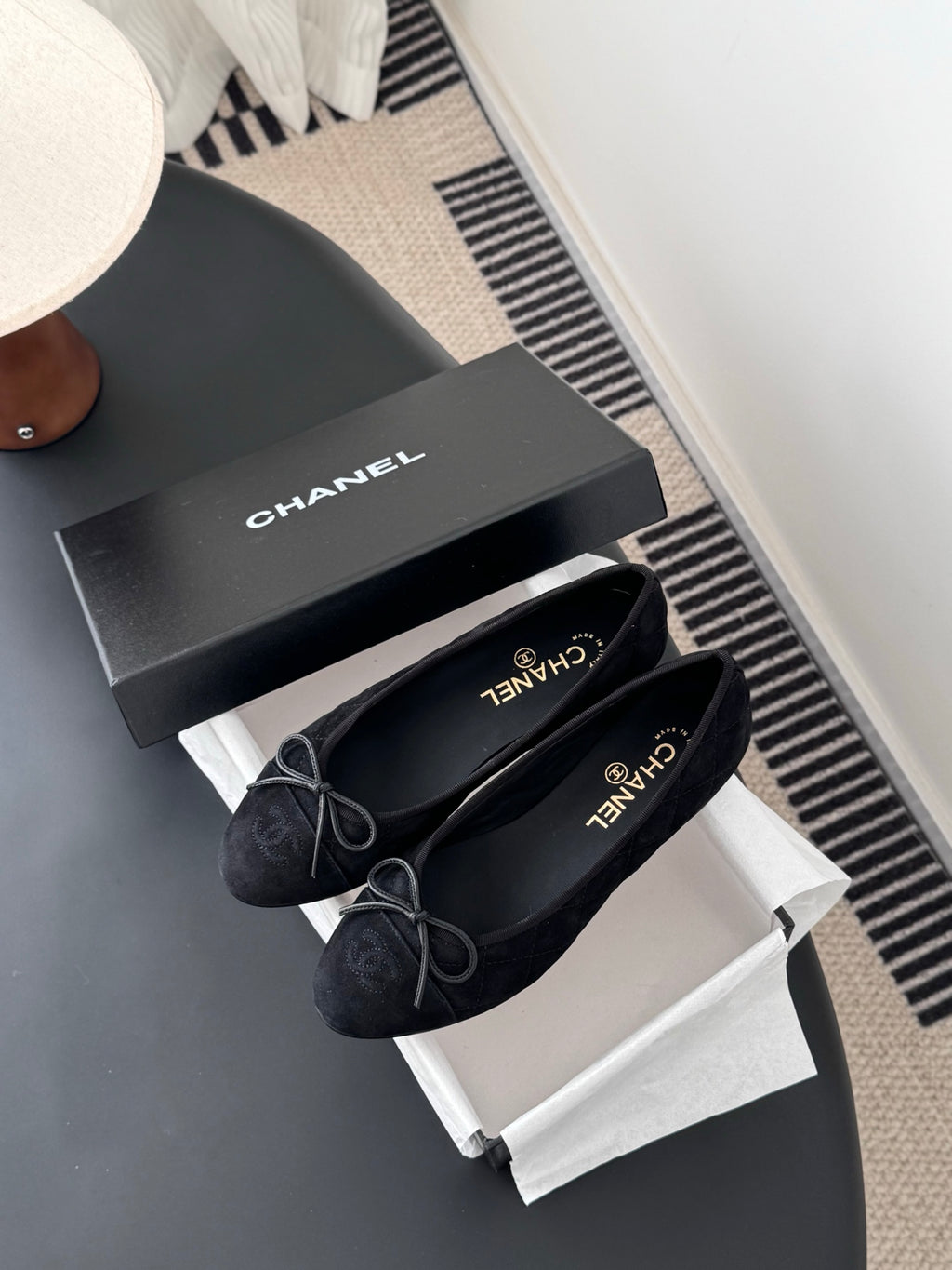Women's dark ballet flats with lace-up bows, Chanel branding on insole