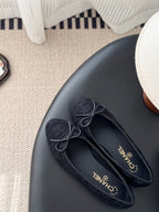 Women's dark lace-up ballet flats with stitched texture and bow ties