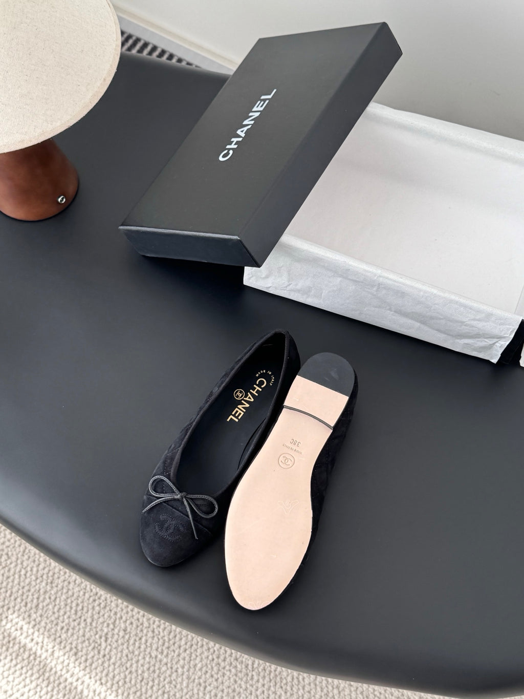 Women's lace-up ballet flats, one dark and one beige, rounded toe