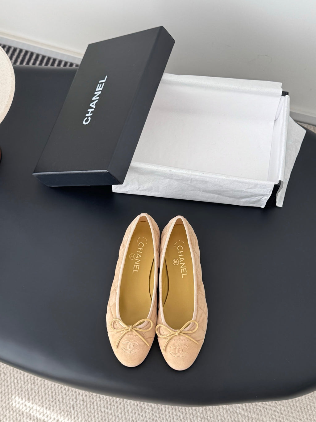 Beige quilted ballet flats with bow detail and round toe, Chanel logo on insole