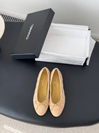 Beige quilted ballet flats with bow detail and round toe, Chanel logo on insole