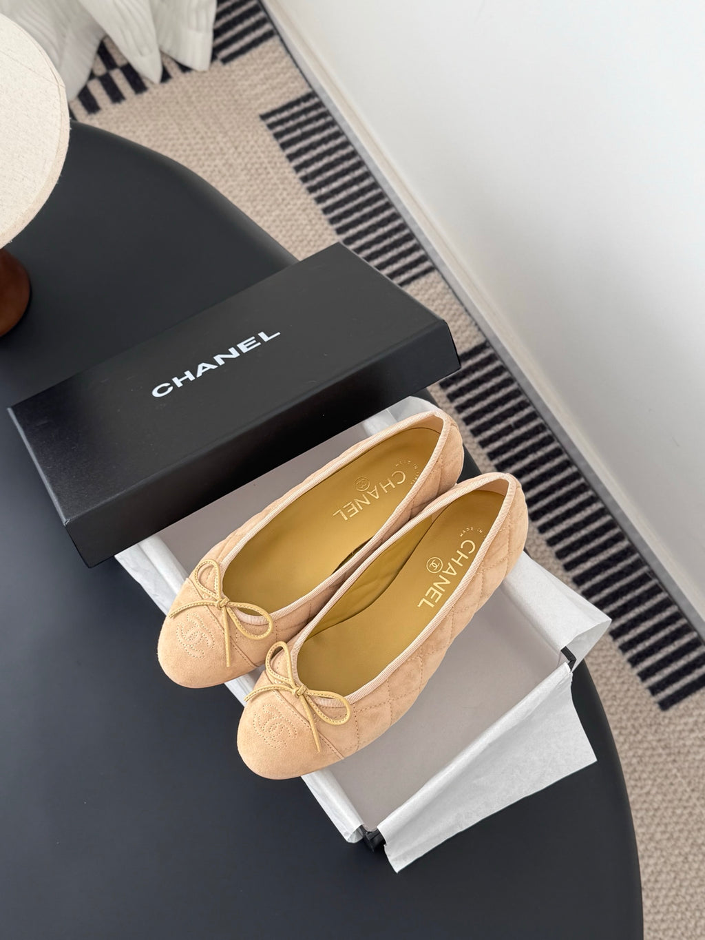 Beige quilted ballet flats with bow at toe, round toe, pair on display with box