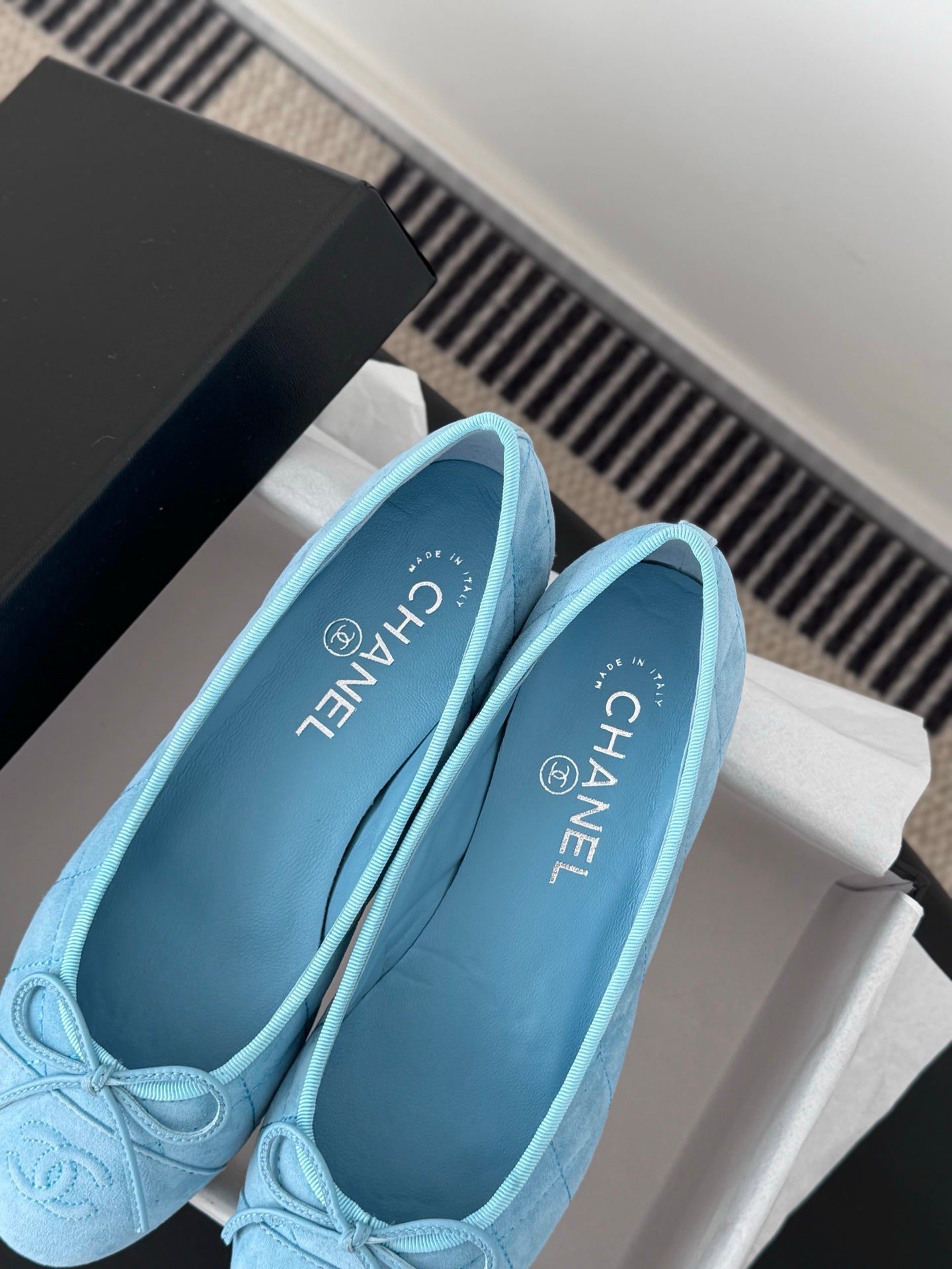 Light blue Chanel ballet flats, close-up showing interior lining and logo