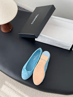 Light blue Chanel ballet flats, one shoe turned to show smooth beige insole