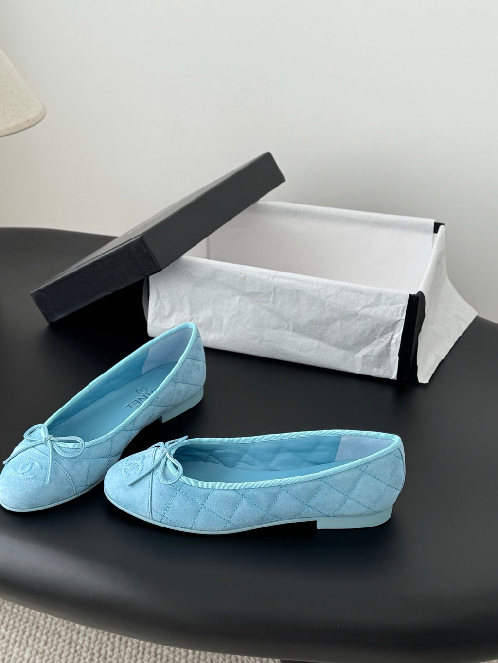Light blue Chanel ballet flats, side view with bow detail and flat heel