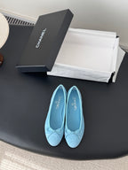 Light blue Chanel ballet flats with bow at toe, quilted texture