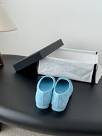 Light blue Chanel ballet flats, back view showing heel and bow top detail