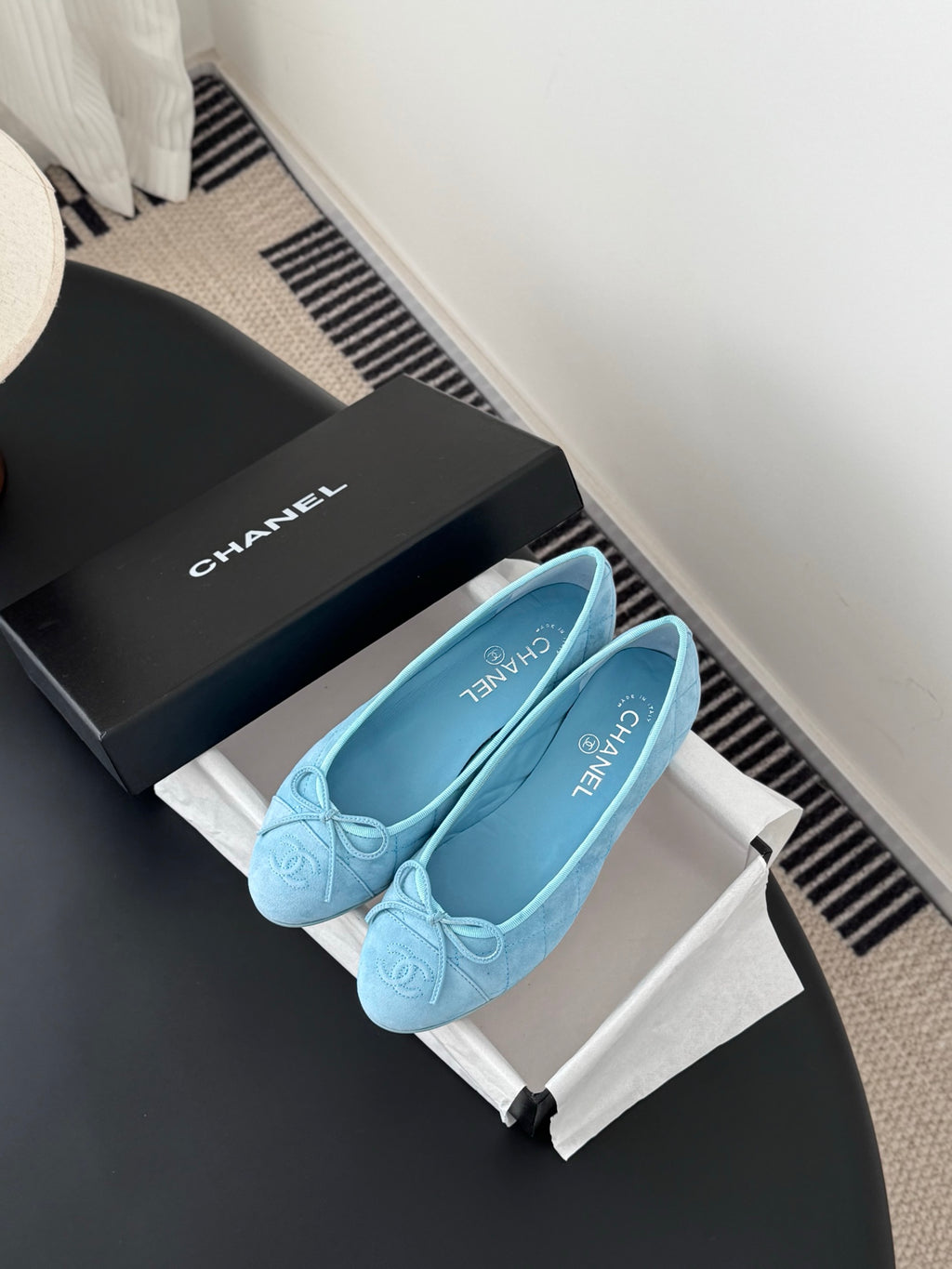 Light blue Chanel ballet flats on box, front view with bow and quilted finish