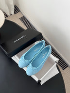 Light blue Chanel ballet flats on box, front view with bow and quilted finish