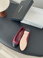 Pink quilted ballet flat with black cap and bow-tied straps